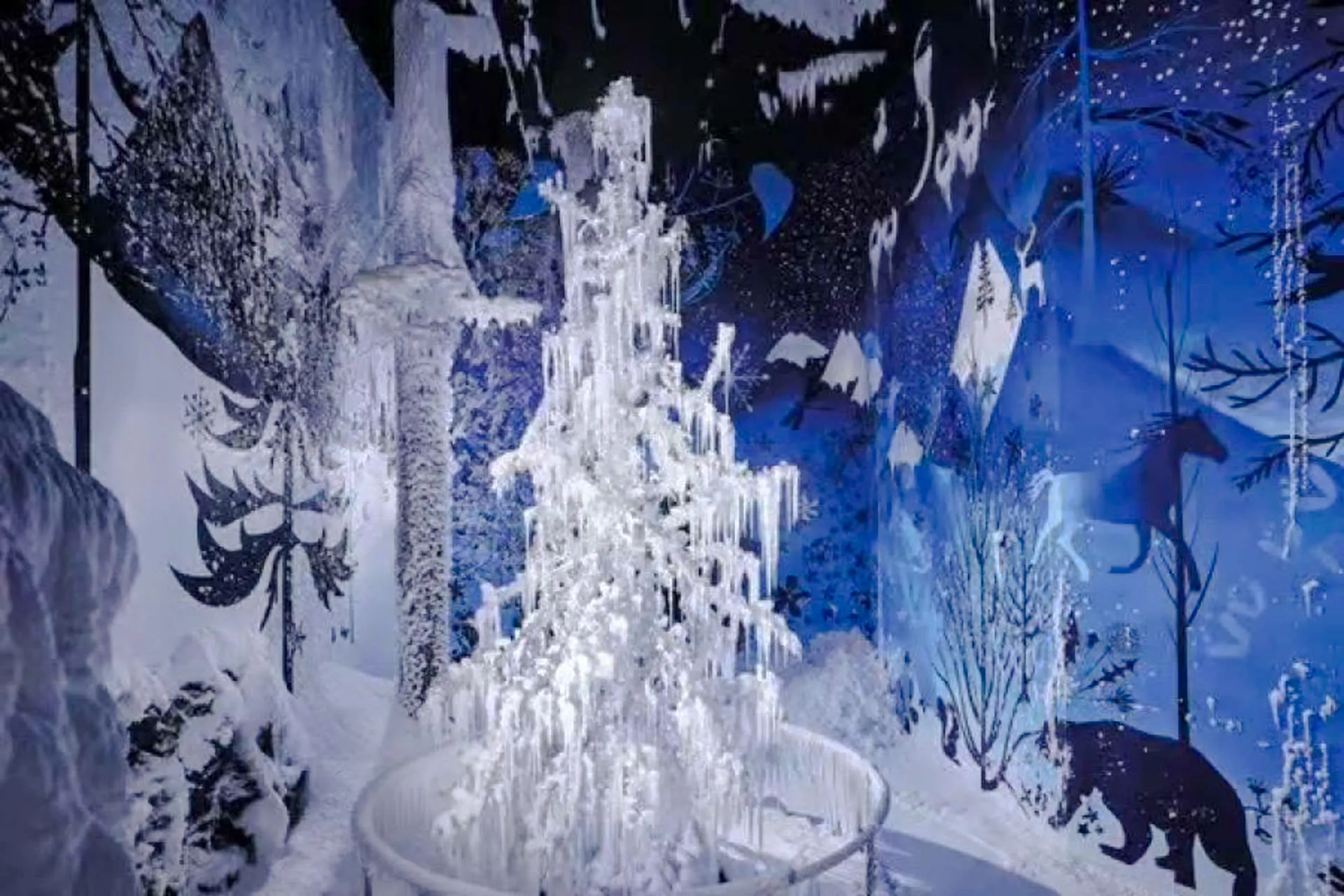 Swarovski Crystal Worlds installation with icy tree and winter-themed mural in Innsbruck.