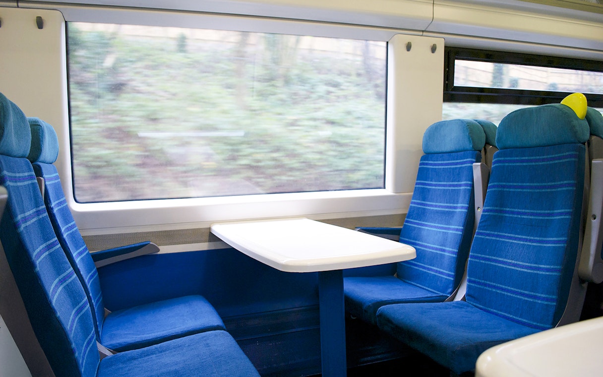 Eurostar train seats with table and window view.