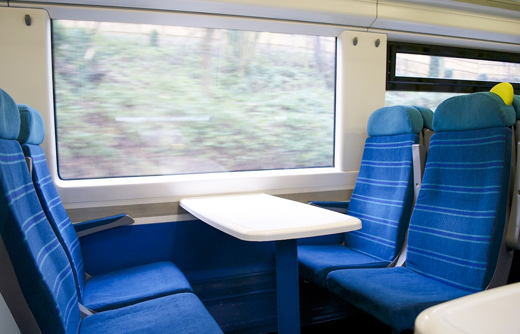 Eurostar train seats with table and window view.