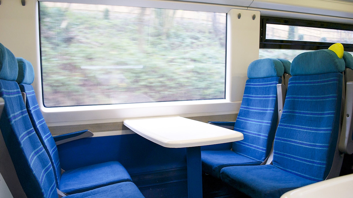 Eurostar train seats with table and window view.