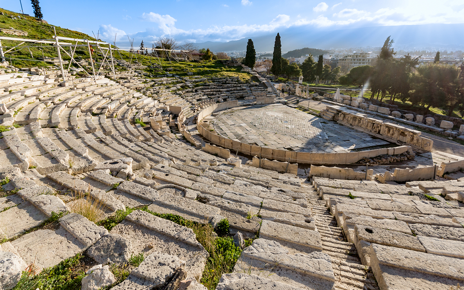 Theatre of Dionysus ruins in Acropolis, Athens, Greece, with stone seating and stage.