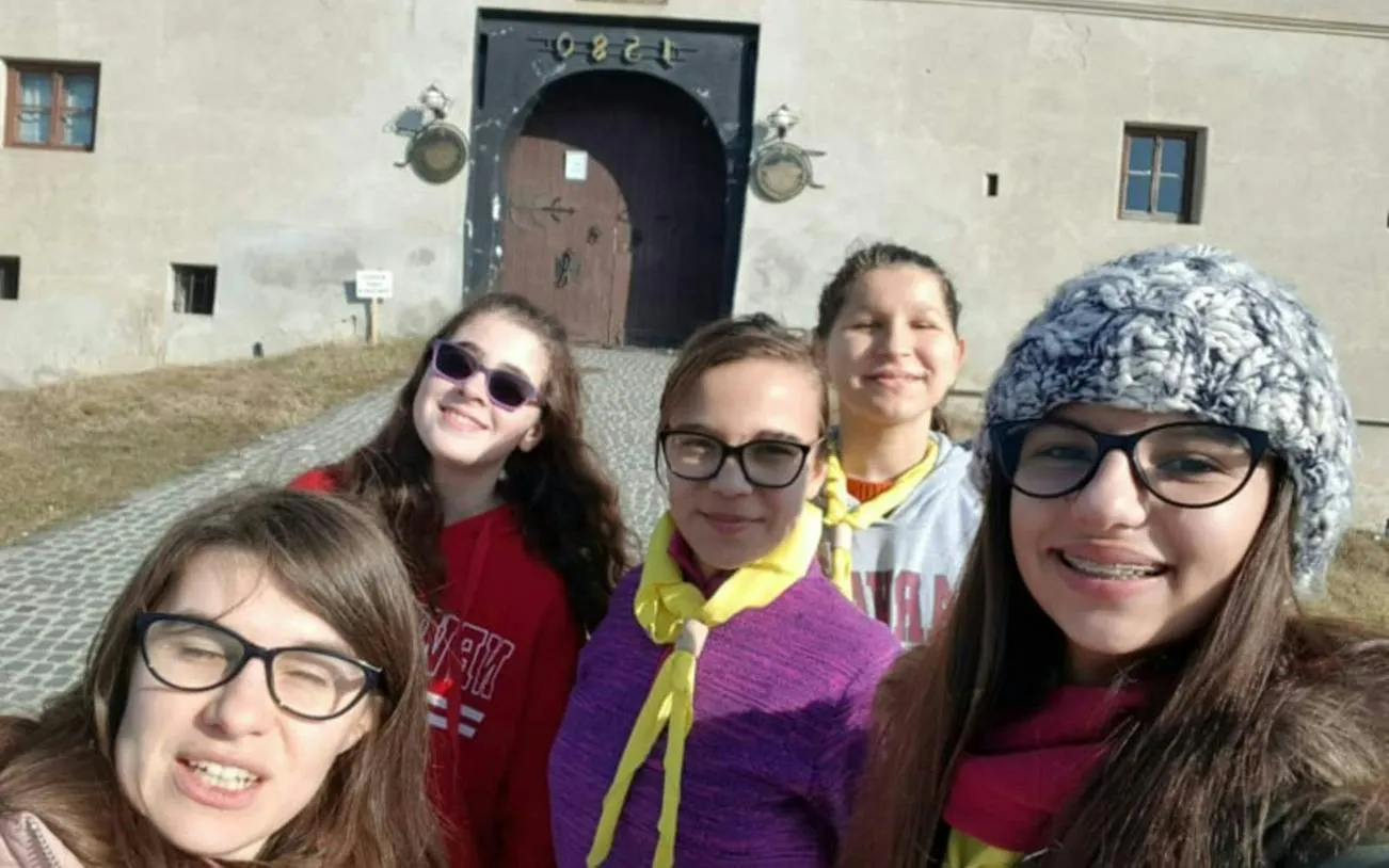 Group of people in front of a historic gate during Brasov self-guided city exploration game.