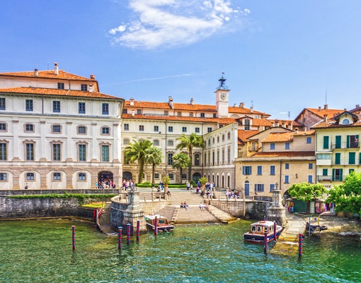 Isola Bella waterfront with historic buildings and boats, Italy.