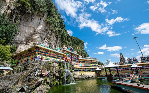 Colorful temple facade and limestone cliffs at Batu Caves, Malaysia.