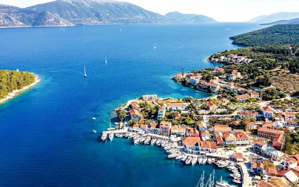 Aerial view of Fiskardo village with boats in the harbor, Kefalonia island, Greece.