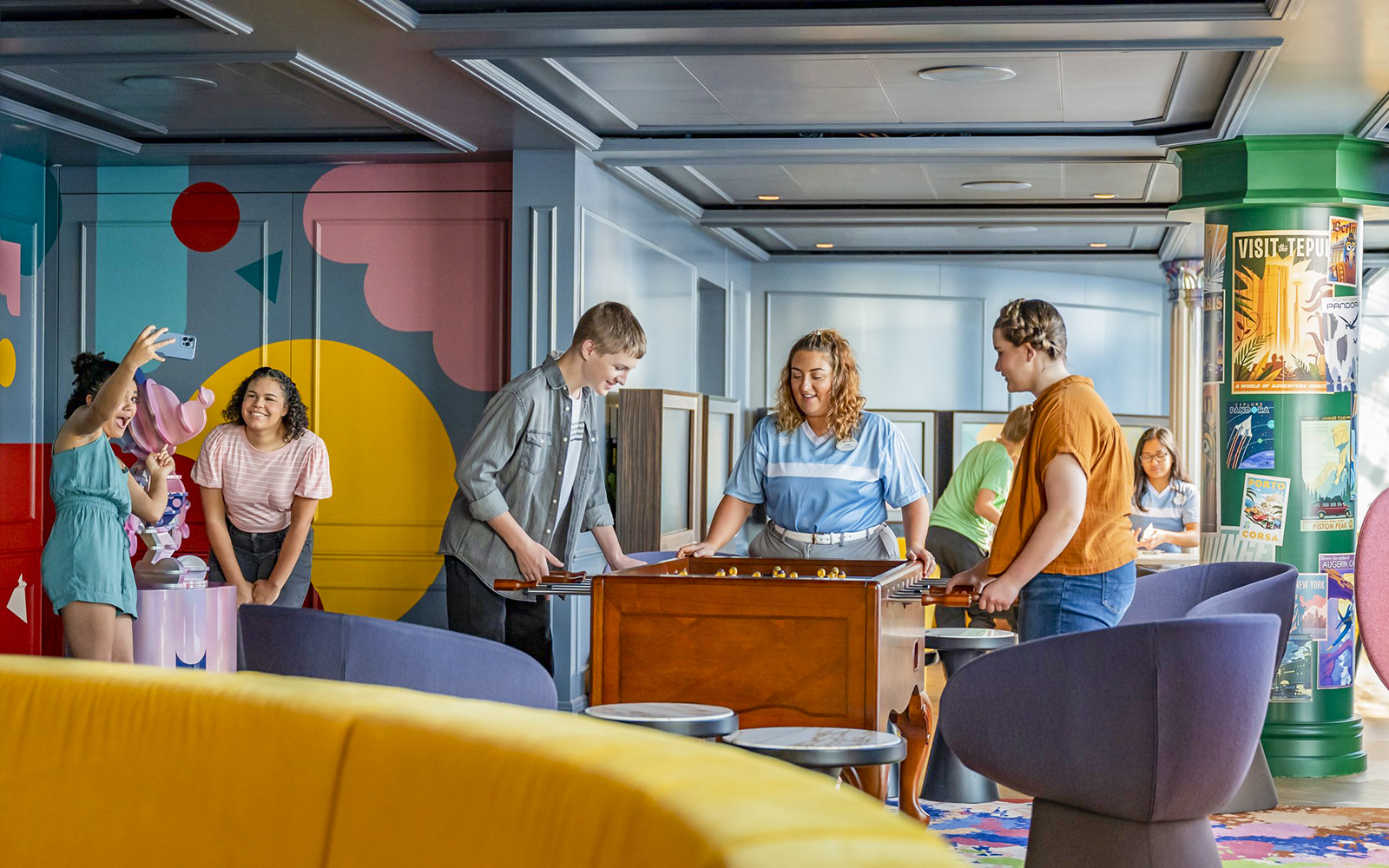 Teens enjoying activities at Vibe club on Disney Cruise ship.