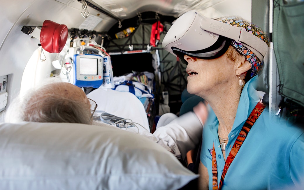 Patient and staff using VR headset on Royal Flying Doctor Service flight, Alice Springs.