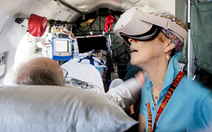 Patient and staff using VR headset on Royal Flying Doctor Service flight, Alice Springs.