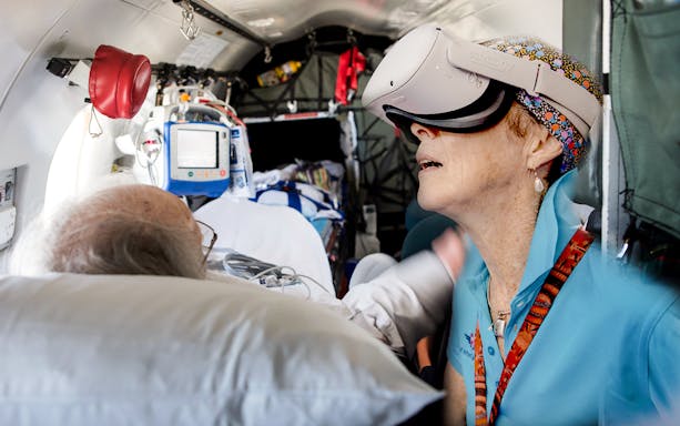 Patient and staff using VR headset on Royal Flying Doctor Service flight, Alice Springs.