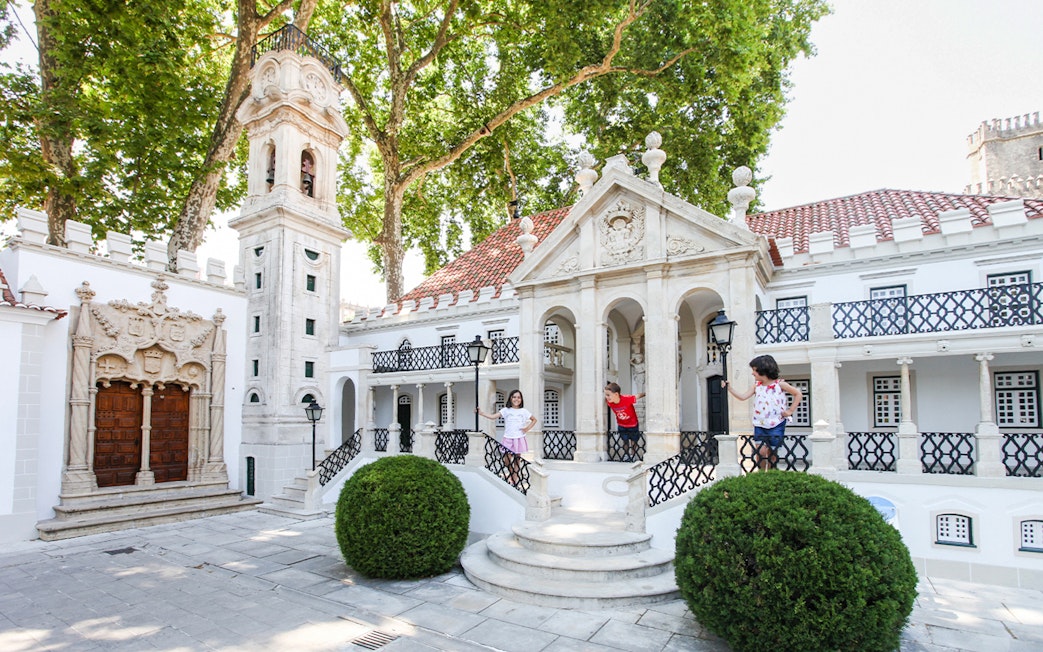 Children exploring miniature buildings at Portugal dos Pequenitos, Coimbra.