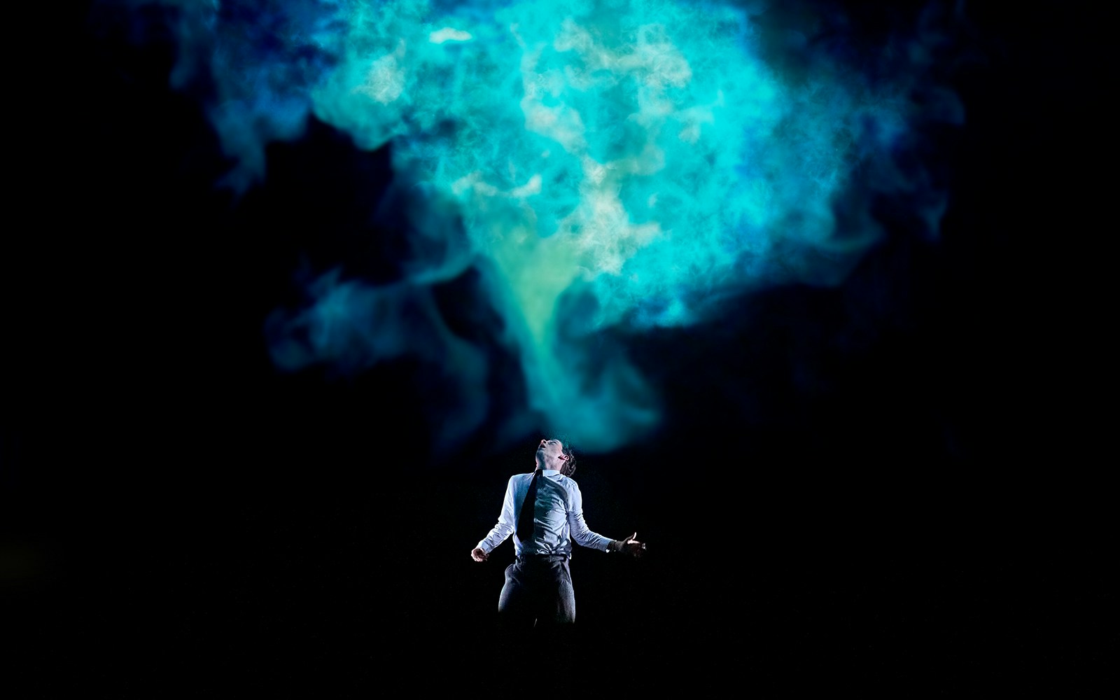 Person standing under blue smoke in a dramatic scene from Stranger Things: The First Shadow.