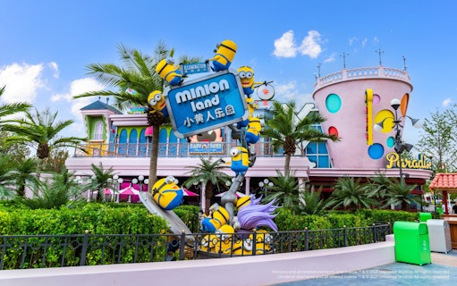Minion-themed entrance at Minion Land, Universal Studios Beijing, featuring colorful buildings and palm trees.