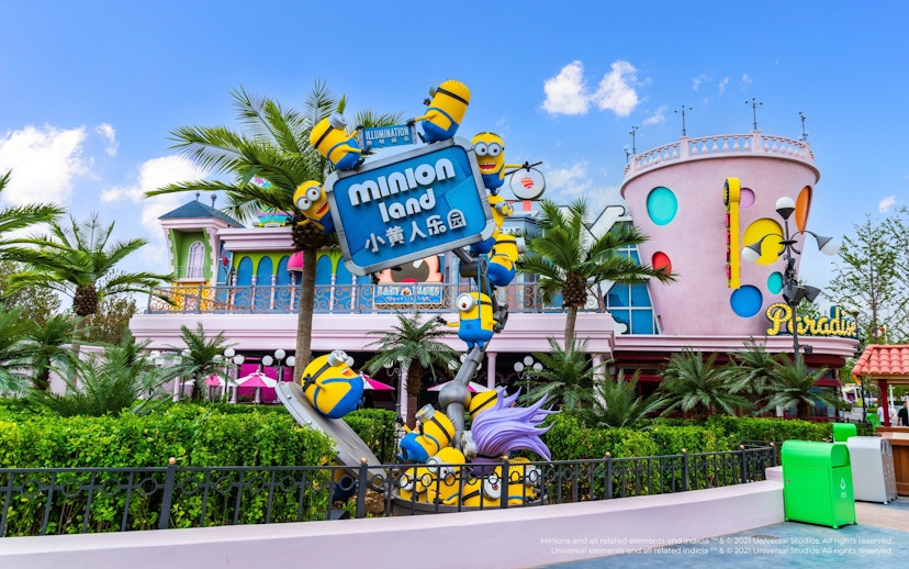 Minion-themed entrance at Minion Land, Universal Studios Beijing, featuring colorful buildings and palm trees.