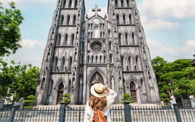 Woman admiring St. Joseph's Cathedral in Hanoi on a guided half-day city tour.