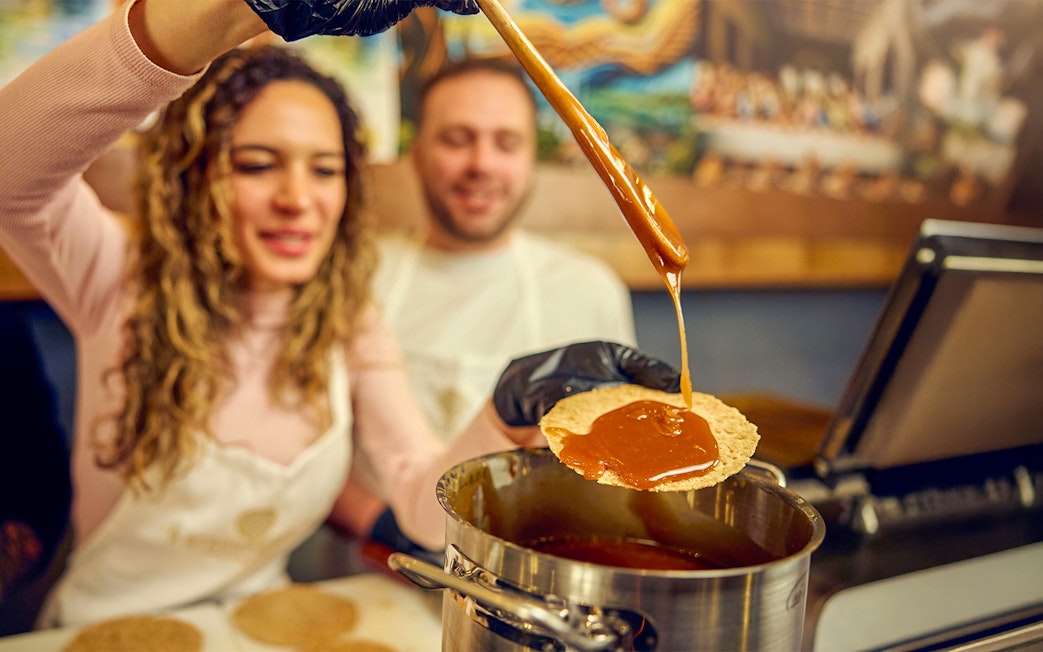 Guests making syrup waffles at a Dutch workshop.