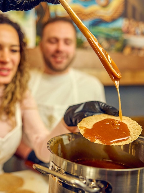 Guests making syrup waffles at a Dutch workshop.
