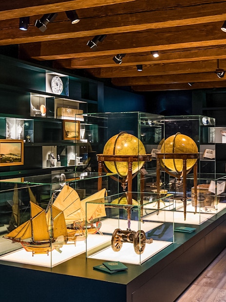 Exhibit of globes and maritime artifacts inside The Maritime Museum, Amsterdam.