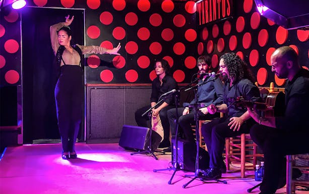 Flamenco dancer performing with musicians in Barcelona's Gothic Quarter.