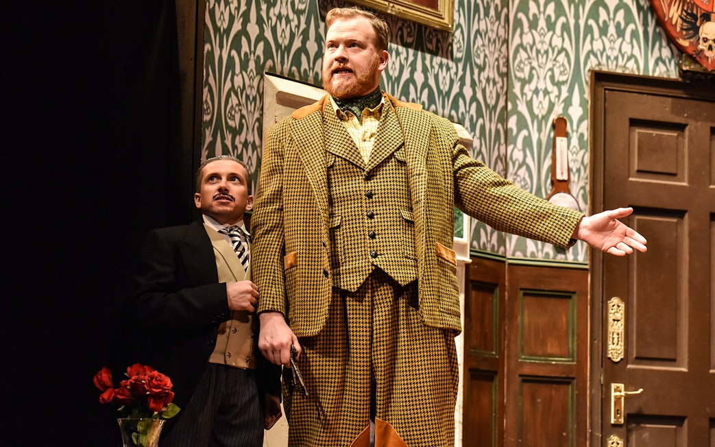 Actors performing a scene from "The Play That Goes Wrong" on stage.