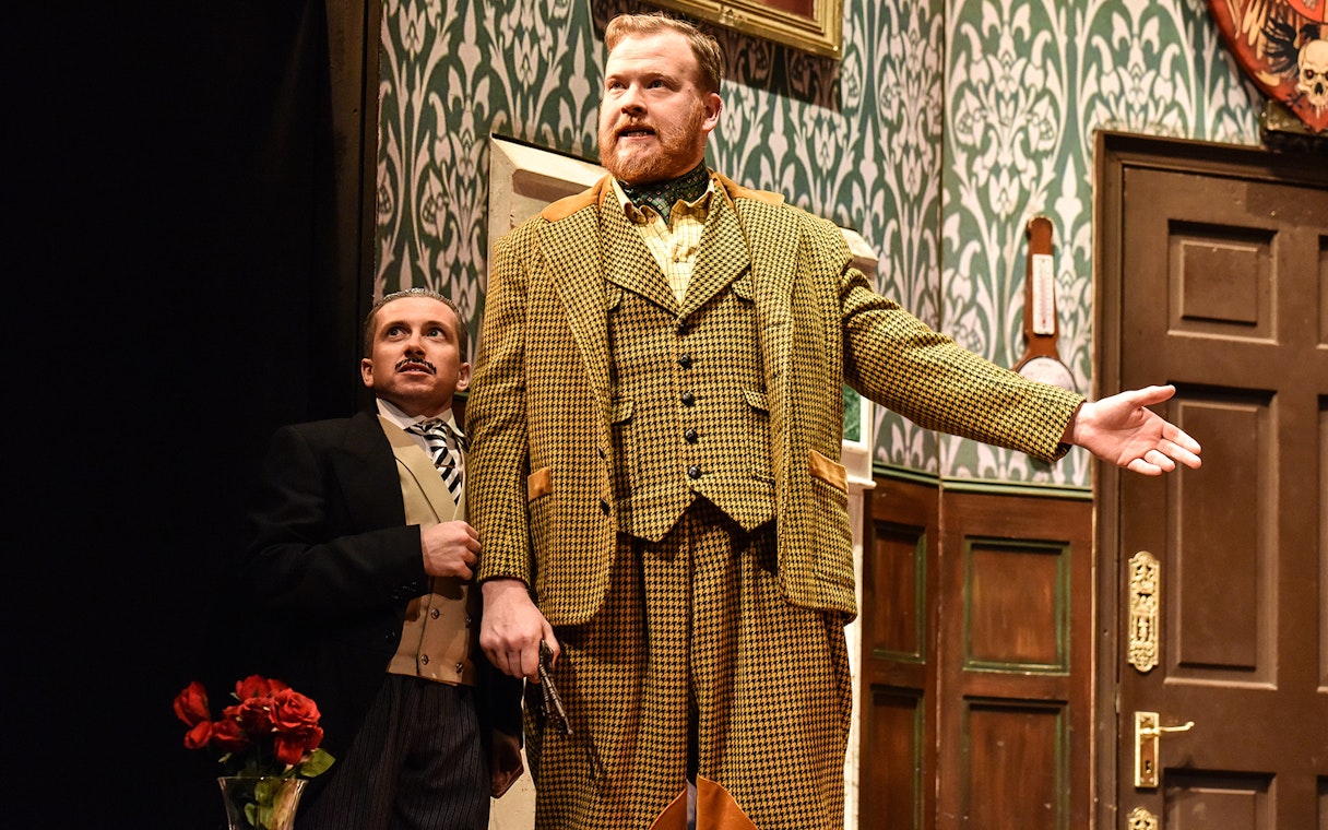 Actors performing a scene from "The Play That Goes Wrong" on stage.