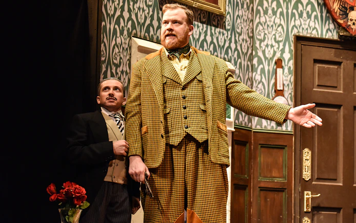 Actors performing a scene from "The Play That Goes Wrong" on stage.