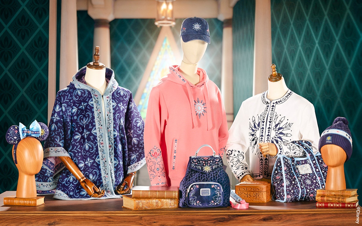 Disneyland World of Frozen merchandise display with themed clothing and accessories.