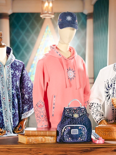 Disneyland World of Frozen merchandise display with themed clothing and accessories.