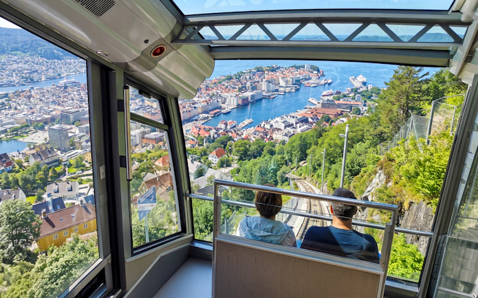 View from funicular descending Mt Floyen overlooking Bergen, Norway with harbor and cityscape.