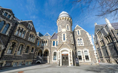 Christchurch Arts Centre historic stone buildings under blue sky.