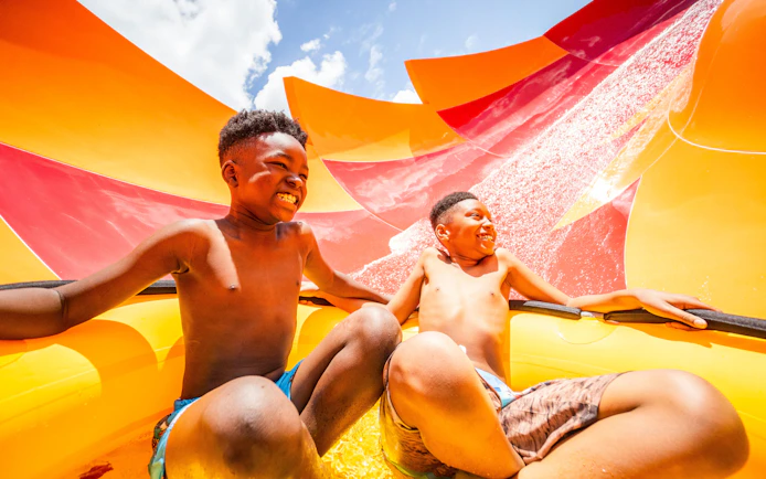 Children enjoying a water slide at Adventure Island, Tampa.