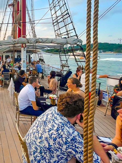 Sunset dinner cruise on The Royal Albatross with guests dining on deck.