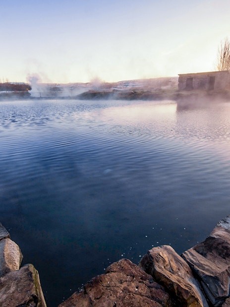 Secret Lagoon hot spring surrounded by stone walls in Gamla Laugin, Iceland.