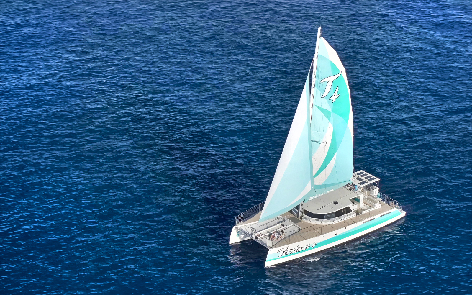 Sailboat on a luxury snorkel tour in Maui, Hawaii, cruising over clear blue ocean waters.