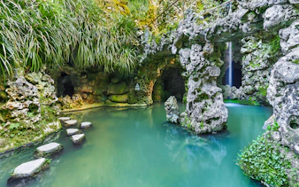 Stepping stones over water in a grotto at Quinta da Regaleira, Sintra.