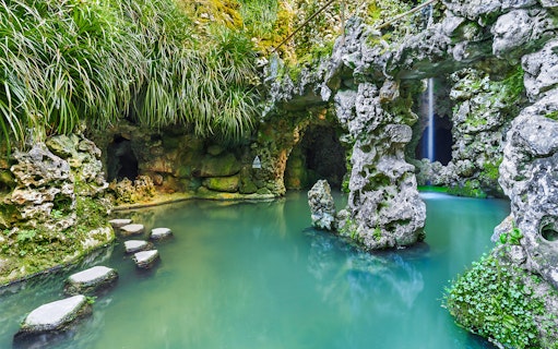 Stepping stones over water in a grotto at Quinta da Regaleira, Sintra.