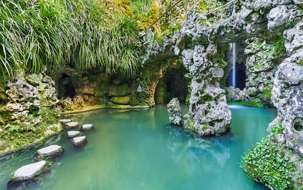 Stepping stones over water in a grotto at Quinta da Regaleira, Sintra.