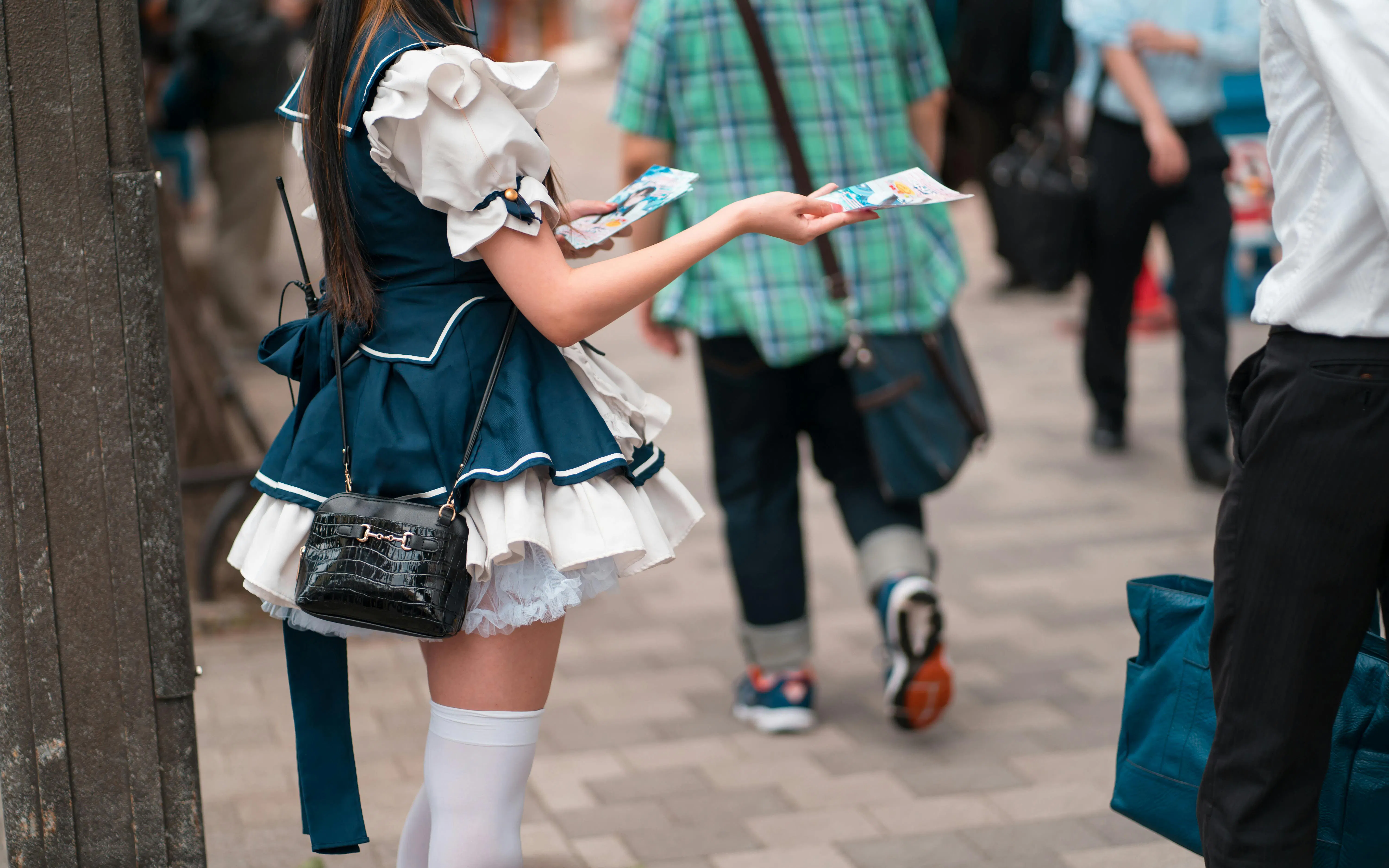 Solicitor handing out flyers on a side street off Chuo-dori, Tokyo.