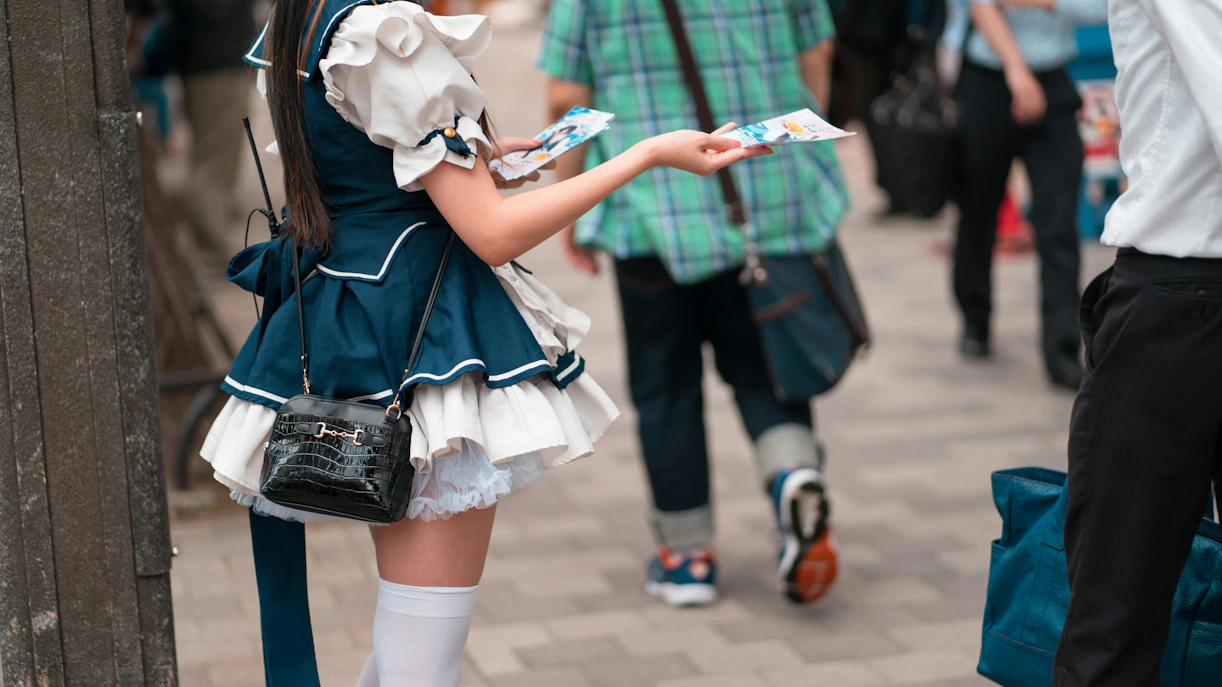 Solicitor handing out flyers on a side street off Chuo-dori, Tokyo.