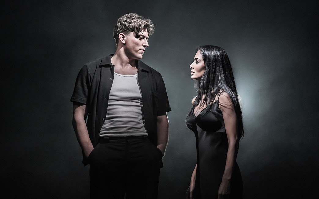 Two actors in dramatic scene on Sunset Boulevard stage.