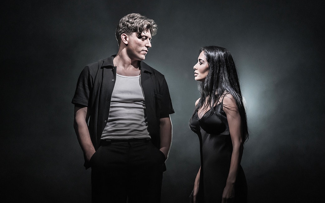 Two actors in dramatic scene on Sunset Boulevard stage.