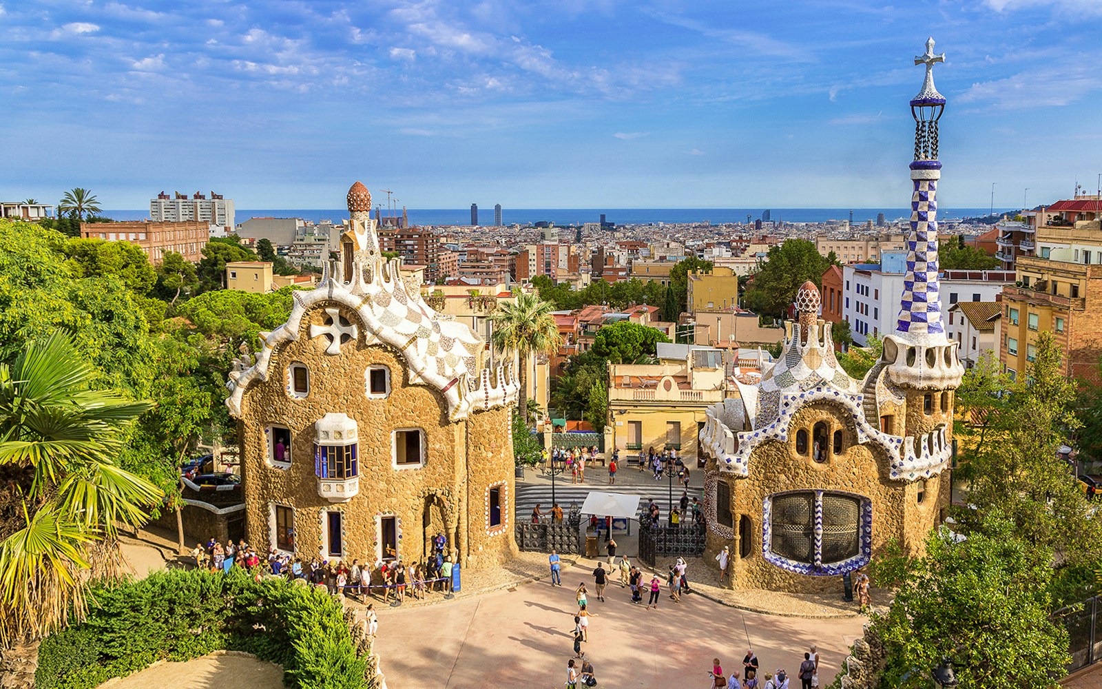 Park Guell entrance with Porter's Lodge pavilions in Barcelona, showcasing unique architectural design.