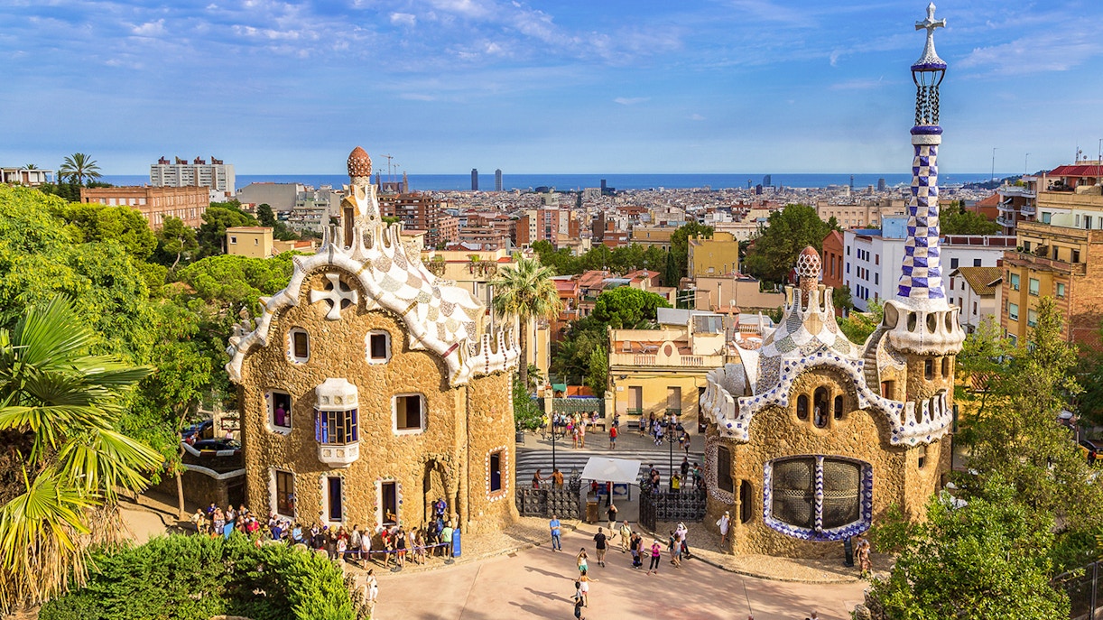 Park Guell entrance with Porter's Lodge pavilions in Barcelona, showcasing unique architectural design.