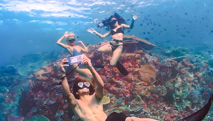 Snorkelers exploring coral reef at the Underwater Museum of Marseille.