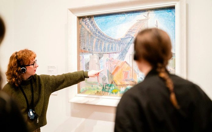 Tour guide explaining artwork at National Gallery of Victoria.