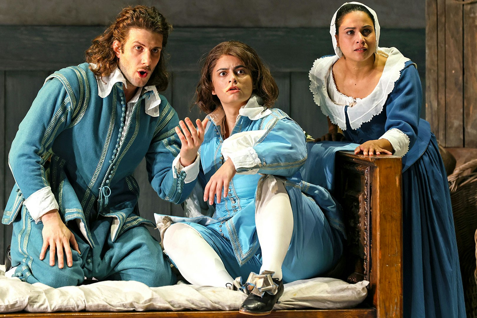 Opera performers in period costumes during a scene from The Marriage of Figaro.