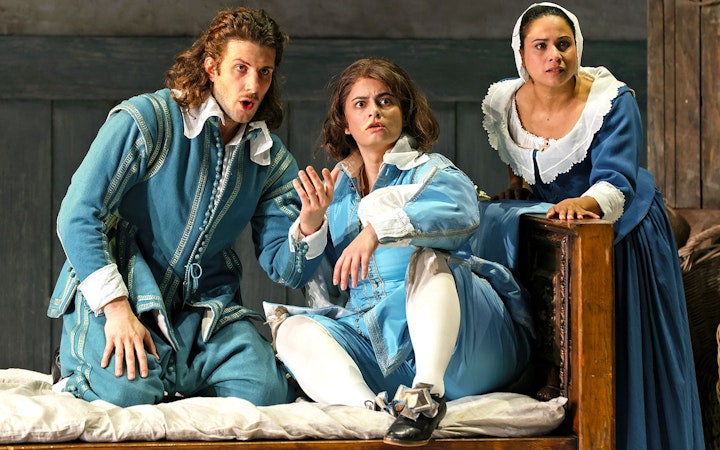 Opera performers in period costumes during a scene from The Marriage of Figaro.