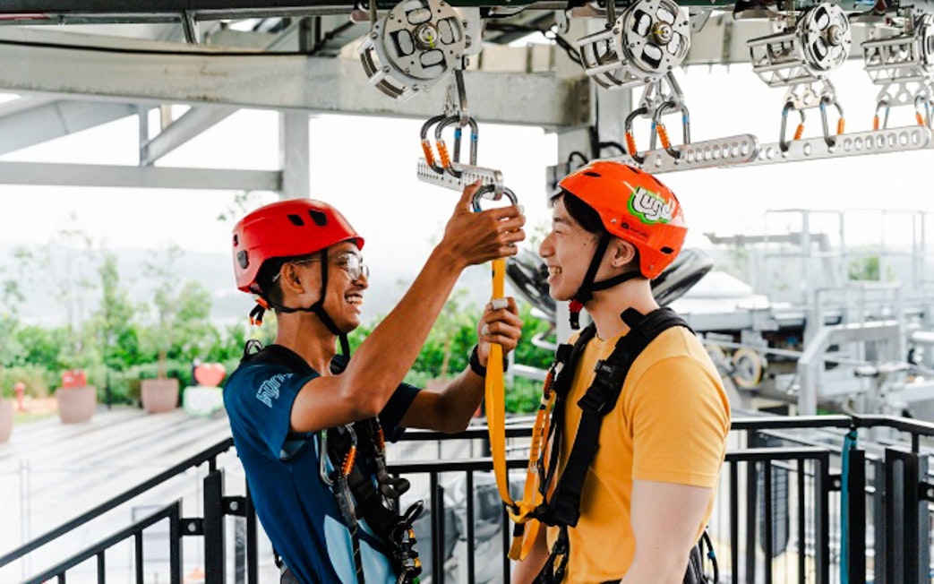 Participants preparing for Skyline Luge ride with safety gear.