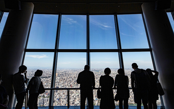 Visitors enjoying city views from Tokyo Skytree Viewing Deck.