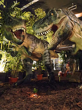 Dinosaurs exhibit at Dinoland Singapore with lush greenery.