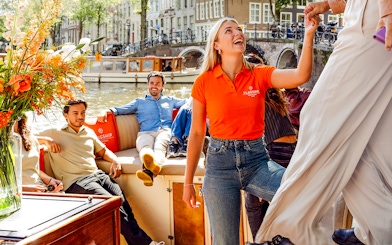 Guests enjoying a canal view on the Luxury Open Boat Cruise in Amsterdam.